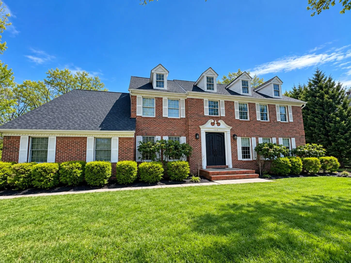 Brick colonial with a finished shingle roof