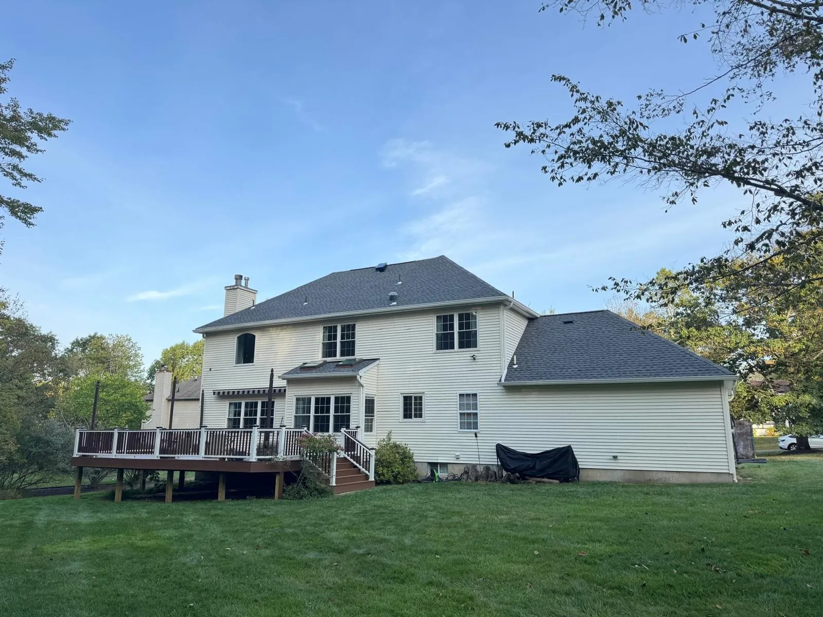 Two-story colonial home with a new shingle roof and rear deck
