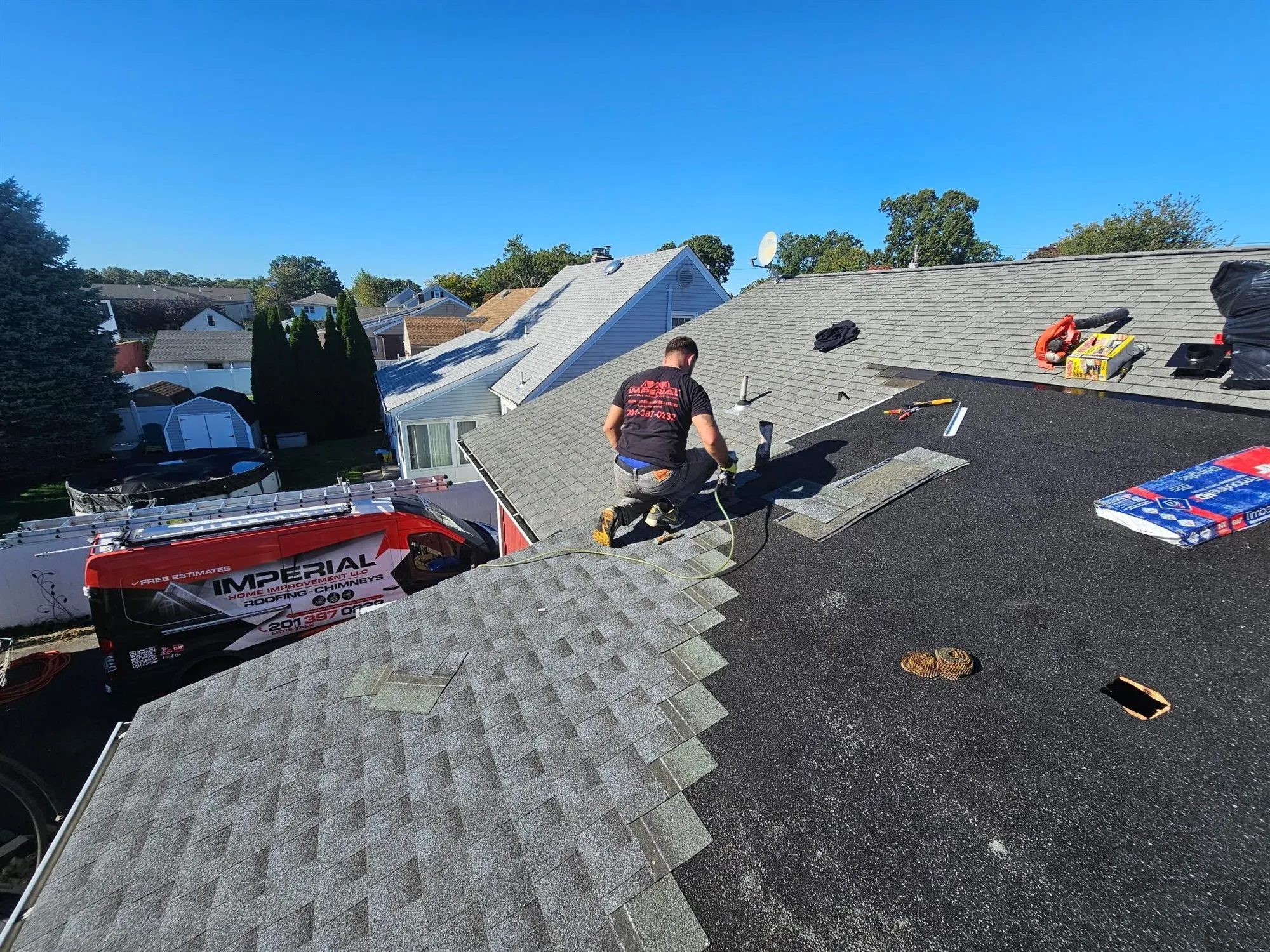 Imperial roofer nailing new shingles over synthetic underlayment