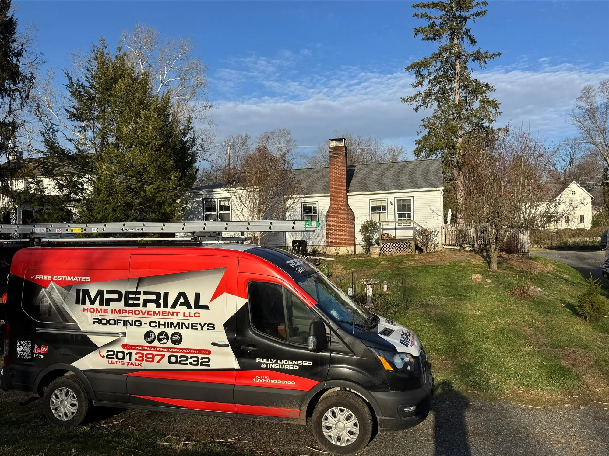 Imperial roofing van parked outside a home during a roof job
