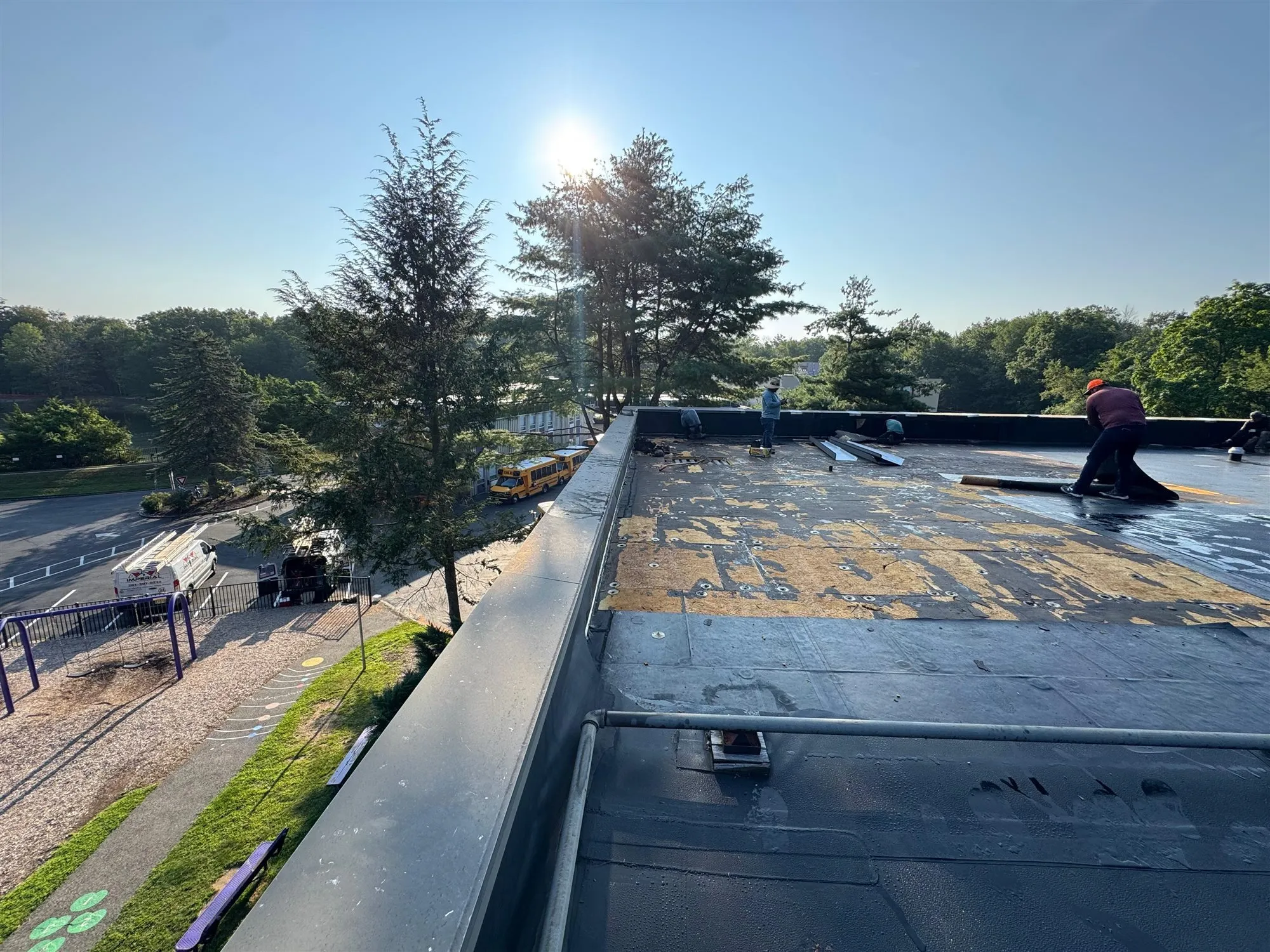 Insulation boards fastened across a flat roof deck before the membrane goes on